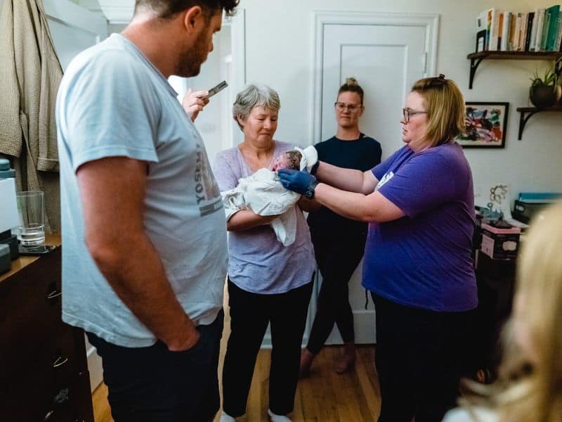 Midwife Tiffany Hoffman at a Home Birth with parents, grandparent and newborn